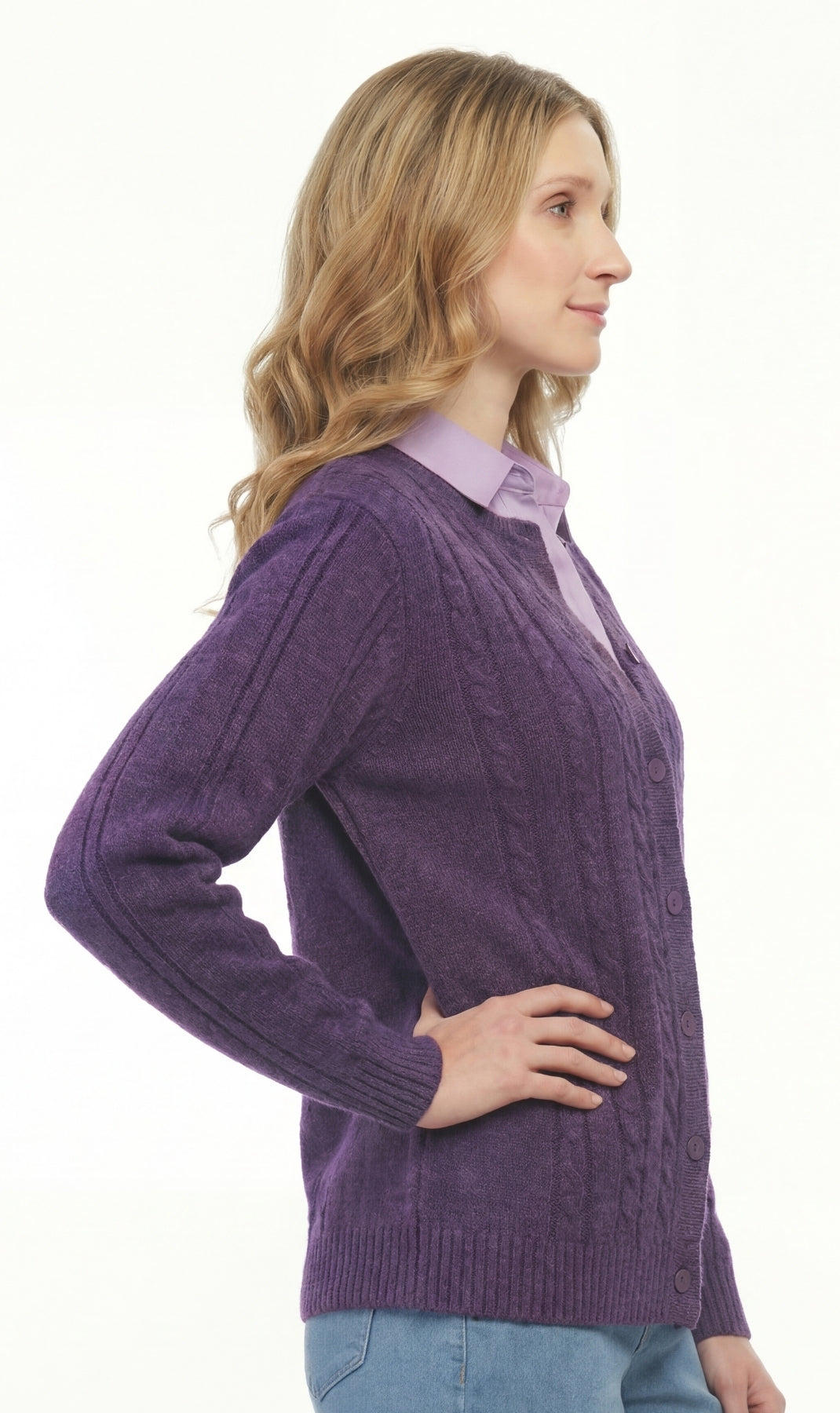 Woman wearing a purple sweater over a light shirt on a white background