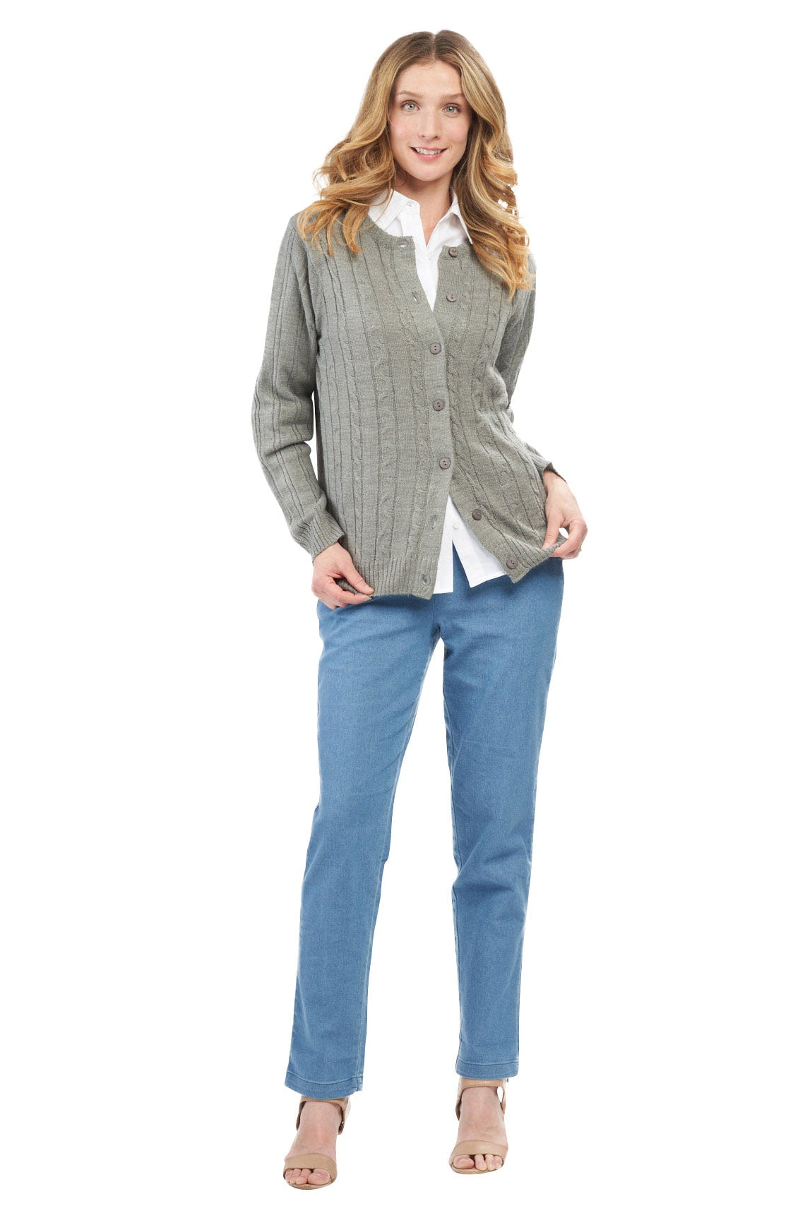 Woman wearing a gray checkered shirt over a white blouse and blue pants on a white background
